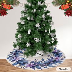 a christmas tree with decorations on it in front of a white wall