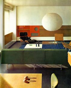 a living room filled with furniture and a large white ball hanging over the top of it