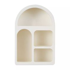 a white plastic shelf with three compartments on each side and an arched opening at the top