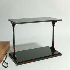 a black table with red lines on it next to a pair of glasses