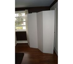 an empty room with white walls and wood flooring is pictured in this image from the doorway