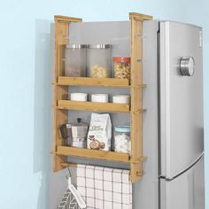 a refrigerator that has some food in it and is next to a towel rack on the wall