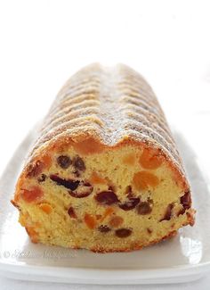 a piece of bread with raisins and nuts on it sitting on a plate