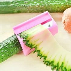 an apple and cucumber slicer on a cutting board