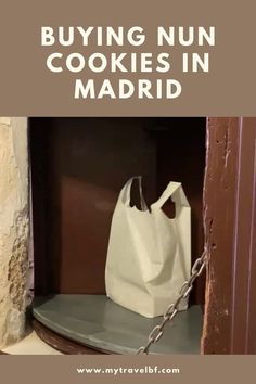 a white bag sitting on top of a shelf in front of a door with the words buying nun cookies in madrid