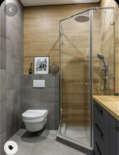 a bathroom with a toilet, shower and sink in it's center area is shown