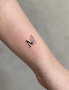 a woman's arm with a tattoo on it that has a shoe and butterfly