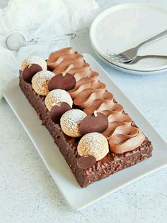 a piece of chocolate cake sitting on top of a white plate