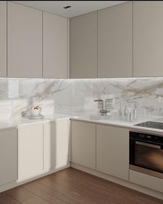 a kitchen with white cabinets and marble counter tops