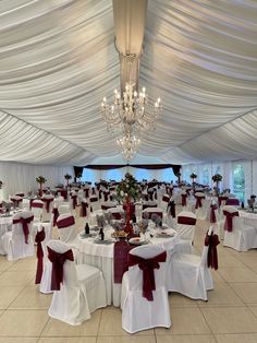 a banquet hall with tables and chairs covered in white linens