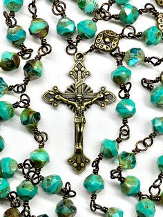 "This five decade Catholic Rosary is made with fifty-three beautiful rustic, earthy, 8 mm green Czech Glass Beads, and six larger Vintage Bronze Metal Beads. This rosary is considered unbreakable due to the wire wrapping technique I use (not a simple loop, but wrapped around). The crucifix is a 2 Inch Vintage Bronze Starburst Crucifix, and is beautifully detailed. The center is a bronze scrolled 3-way. Your Rosary will be shipped in an nice organza pouch, and will include a pamphlet \"How To Pra Handmade Artisan Rosary, Artisan Handmade Rosary, Protestant Prayer Beads, Beautiful Rosary, Rosary Jewelry, Beads Rosary, Wire Wrapping Techniques, Decade Rosary, Praying The Rosary