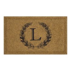 a door mat that has the letter l on it and a laurel wreath around it