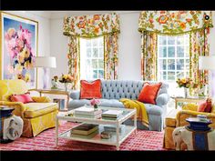 a living room filled with furniture and colorful curtains