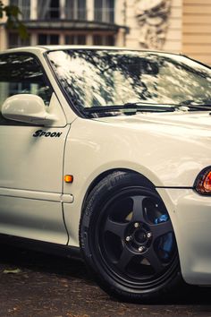 a white car parked in front of a building