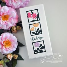 a card with flowers and the words thank you written on it next to some pink flowers