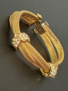 Petite fit slim wrist Vintage 1960s 1970s gold tone mesh twist bracelet bangle with clear diamanté glass paste stones 17.5cm long overall dulling on plate .. more of champagne gold now Gold Rhinestone Cuff Bangle Bracelet, Gold Rhinestone Cuff Bangle, Vintage Yellow Gold Bracelets For Parties, Vintage Gold-tone Bracelets For Party, Gold Costume Jewelry Bracelets For Evening, Twist Bracelet, Ruby Earrings Studs, Twisted Bracelet, Mesh Bracelet