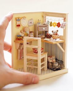 a doll house made out of wood with a desk and chair in front of it