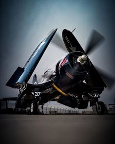 a small propeller plane sitting on top of an airport tarmac