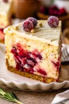 a slice of cake with white frosting and berries on top