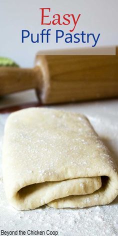 homemade puff pastry on a floured surface with rolling pin in the background and text overlay that reads easy puff pastry beyond the chicken coop