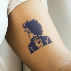 a woman's arm with a tattoo on it that has an image of a person