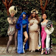 three women dressed in costumes posing for a photo