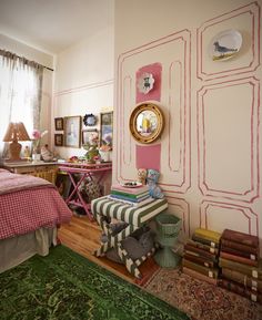 a bedroom decorated in pink and green with pictures on the wall, rugs and bed