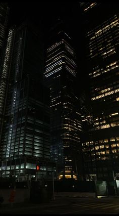 some very tall buildings lit up at night