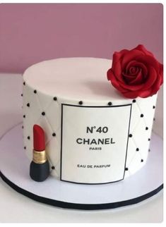 a chanel cake with a red rose on top