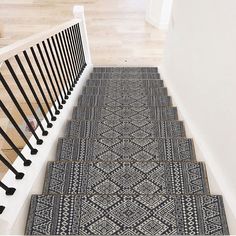 the stairs are decorated with black and white rugs