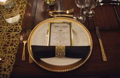 a place setting with gold and black accents