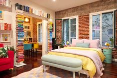 a bedroom with brick walls and lots of books on the shelves