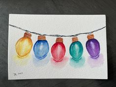 a watercolor painting of christmas lights hanging from a wire on a piece of paper