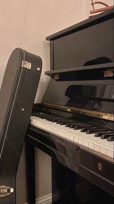 a black case sitting on top of a piano