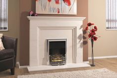 a living room with a fire place in the center and a painting on the wall