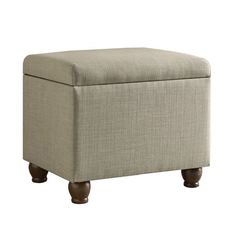 the foot stool is upholstered with wood legs and a light colored fabric cover