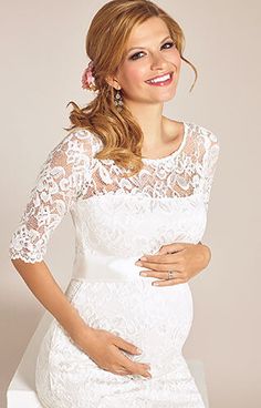 a pregnant woman wearing a white lace dress