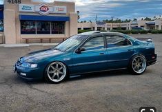 a blue car is parked in front of a gas station with no one around it