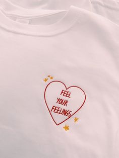 a t - shirt with the words feel your feelings embroidered on it's chest