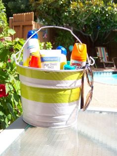 a bucket filled with cleaning products sitting on top of a table next to a pool