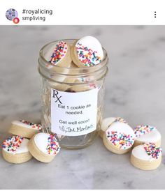 a jar filled with cookies and sprinkles on top of a table