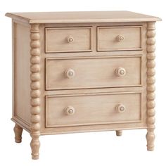 a wooden dresser with three drawers and two knobs