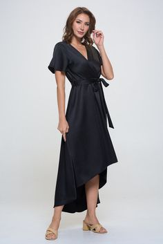 Our Satin Woven Georgia Faux Wrap Dress exudes a sophisticated and elegant feel. A faux wrap tie-waist detail and a hi-low hem that effortlessly flows with every movement. Pair it with a statement necklace and heels for a glamorous look. Prepare to turn heads at any event, from garden parties to evenings. Made in USA. Material - 100% Polyester. Machine washable. Woman Weaving, Garden Parties, Satin Color, Plus Size Maxi Dresses, Pattern Sweater, Satin Material, Black Wrap Dress, Faux Wrap Dress, High Low Hem