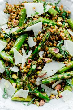 asparagus and lentils with parmesan cheese in a white bowl on a table