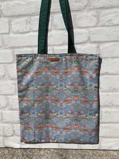 "The strawberry thief by William Morris 100% cotton tote bag measures 14\" X 16\" with 21\" length handles so can be carried on your shoulder, is fully lined for stability in a bottle green cotton  cotton. Ideal for shopping, books etc etc comes with a matching free coin purse which is also fully lined. measurements aprox 14\" X 16\" handle length 21\" fully lined ." The Strawberry Thief, Mandala Elephant, Fidget Blankets, Strawberry Thief, Dolls Prams, Yoga Mat Bag, Mat Bag, Frame Bag, Handmade Blanket