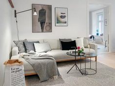 a living room filled with furniture and pictures on the wall