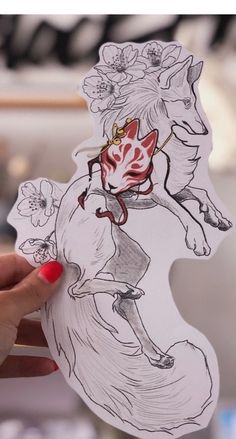 a person holding up a sticker with an image of a horse on it's back