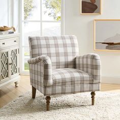 a living room with a plaid chair and rug