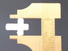 a close up of a wooden ruler with a white cross on the front and side