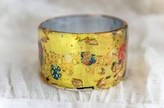 Hand Painted Gold Bracelets For Gift, Gold Hand Painted Bracelets As Gift, Gold Hand Painted Bracelets For Gift, Artsy Bracelet Jewelry Gift, Artistic Gold Bracelets For Gifts, Artistic Adjustable Bangle As Gift, Adjustable Hand Painted Gold Bracelet, Wearable Art Bangle Bracelet Gift, Wearable Art Bangle Bracelet For Gift